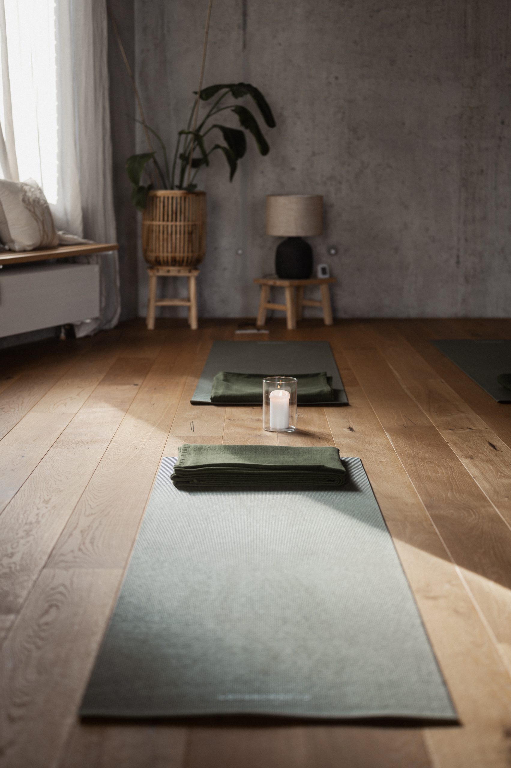 A serene meditation space with yoga mats neatly arranged on a wooden floor